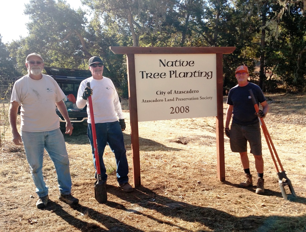 Cory, Pat and Joe with the new sign at the Carmelita planting site.